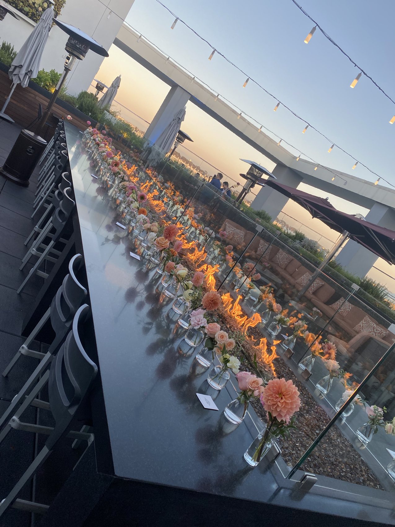 Rooftop dinner table set with florals for a healthcare provider customer event