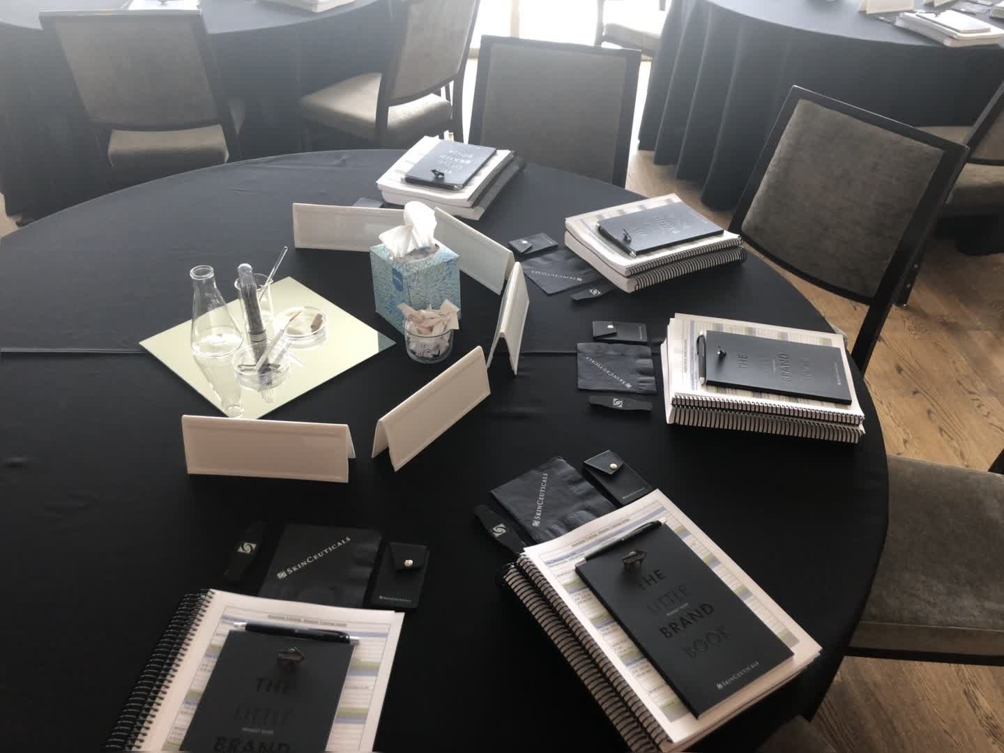 Onboarding materials and brand guides set out for a new-hire training session